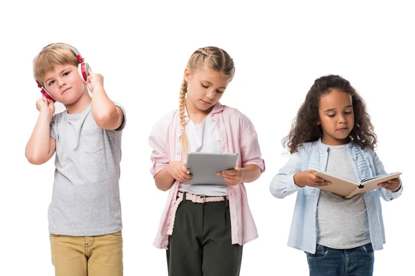 Children with gadgets and book — Stock Photo