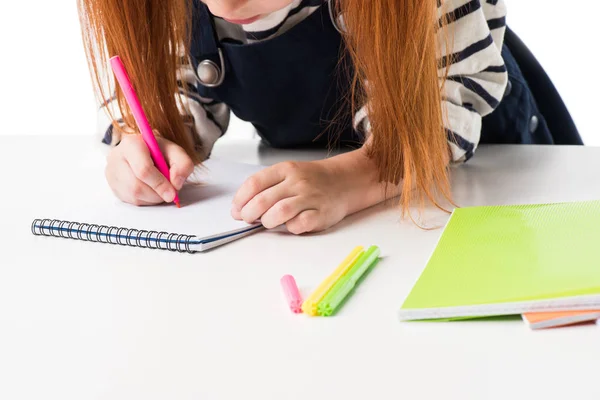 Schoolgirl drawing in notebook — Stock Photo