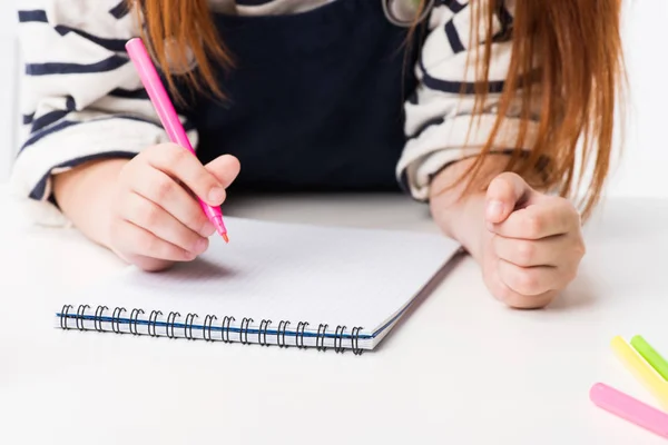 Schoolgirl drawing in notebook — Stock Photo