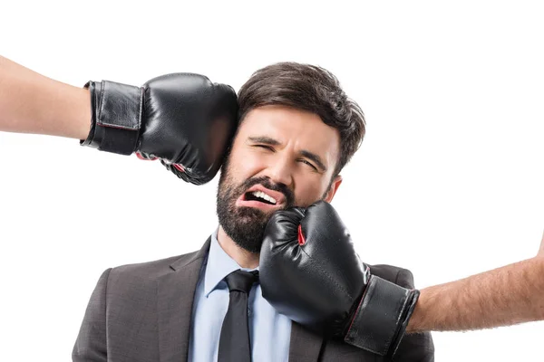 Boxers punching businessman — Stock Photo