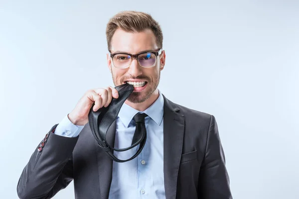 Businessman biting necktie — Stock Photo