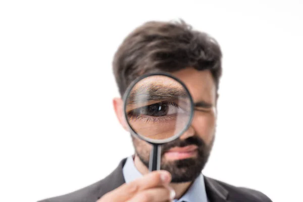 Businessman with magnifying glass — Stock Photo