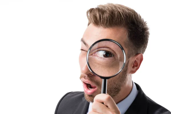 Businessman with magnifying glass — Stock Photo