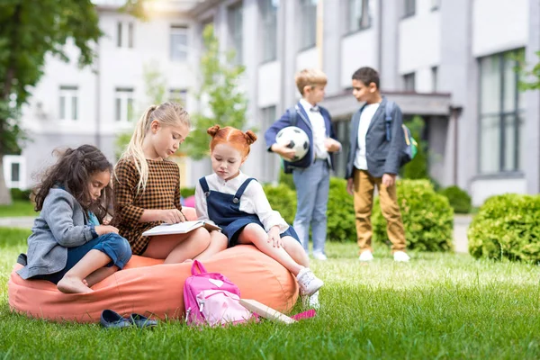 Multiethnic kids on schoolyard — Stock Photo