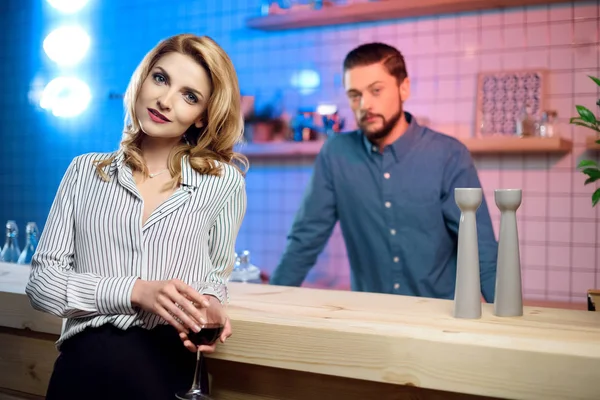 Woman drinking wine in bar — Stock Photo