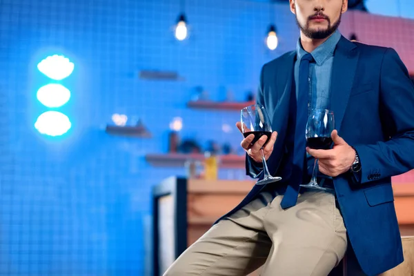 Bearded man with glasses of wine — Stock Photo