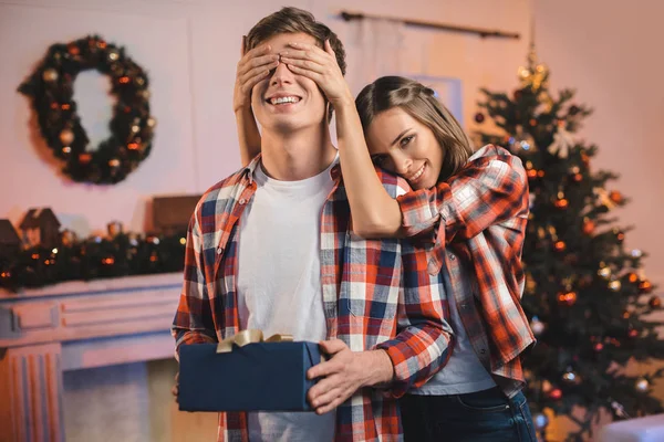 Girl surprising boyfriend on christmas — Stock Photo