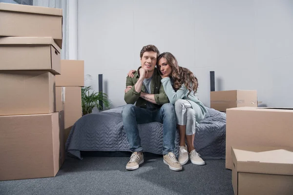 Couple sitting on bed at home — Stock Photo