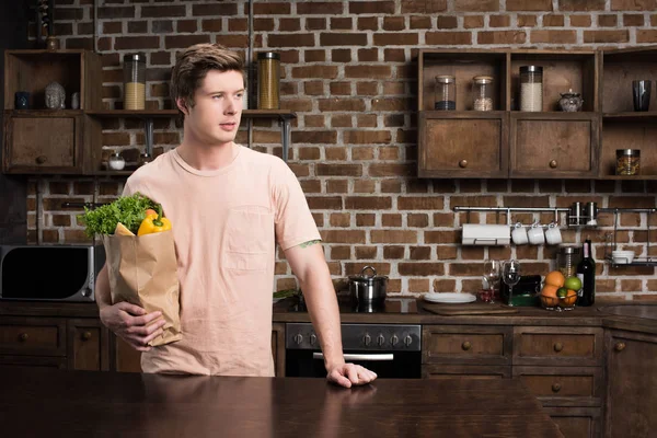 Hombre sosteniendo bolsa de papel con comida - foto de stock