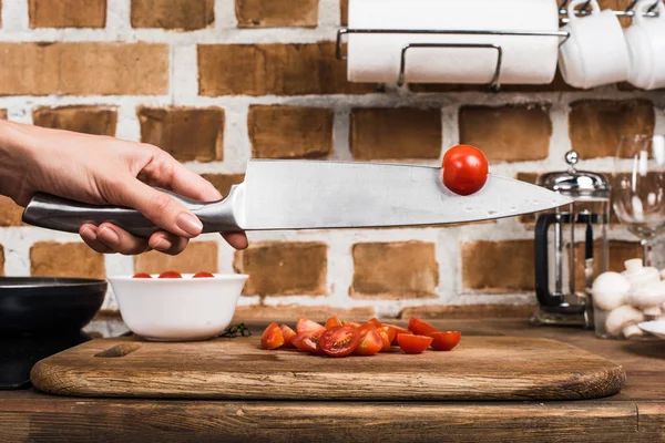 Cherry tomato on knife — Stock Photo