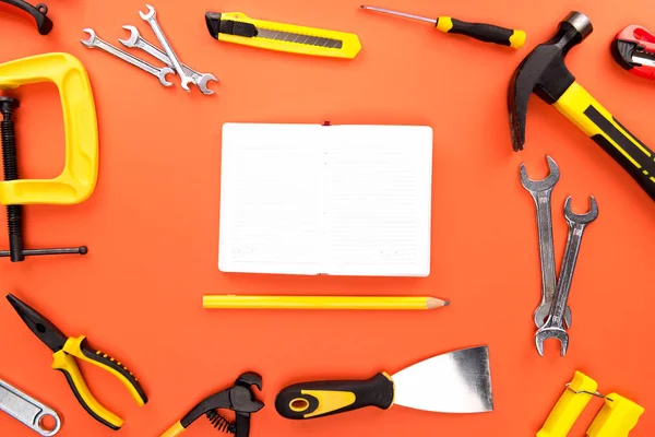 Open notebook and reparement tools — Stock Photo