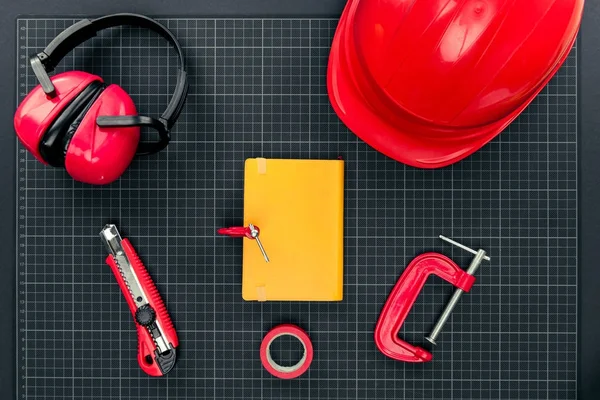 Construction equipment and notebook — Stock Photo