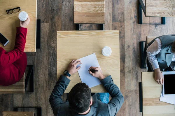 Businesspeople sitting in cafe — Stock Photo