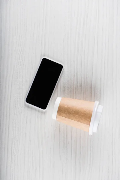 Smartphone and disposable cup — Stock Photo