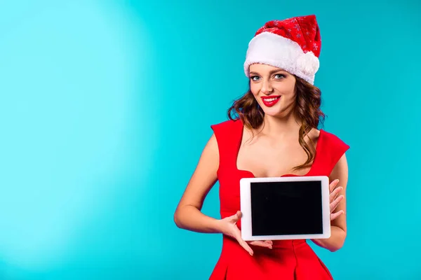 Frau mit Weihnachtsmütze präsentiert Tablet — Stockfoto