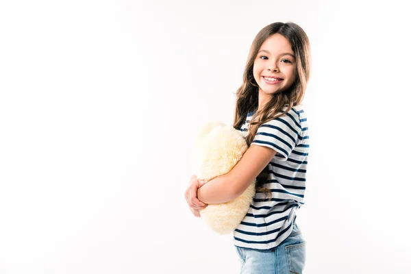 Enfant debout avec oreiller en forme de coeur — Photo de stock