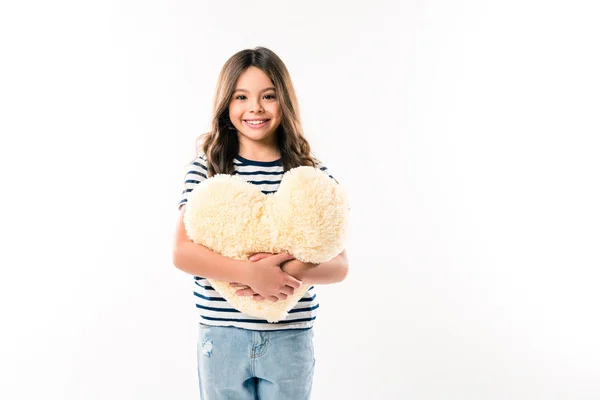 Kid holding heart shaped pillow — Stock Photo