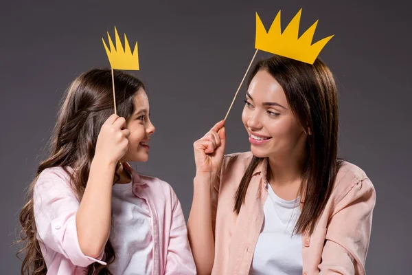 Daughter and mother holding paper crowns — Stock Photo