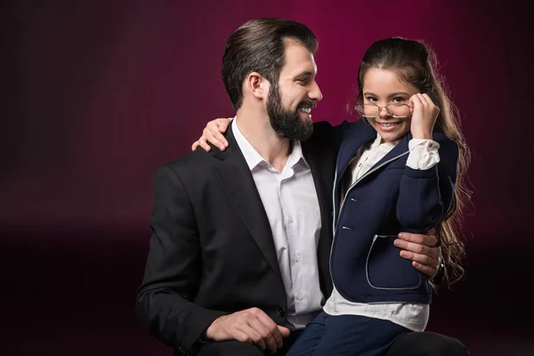 Daughter looking above glasses on burgundy — Stock Photo