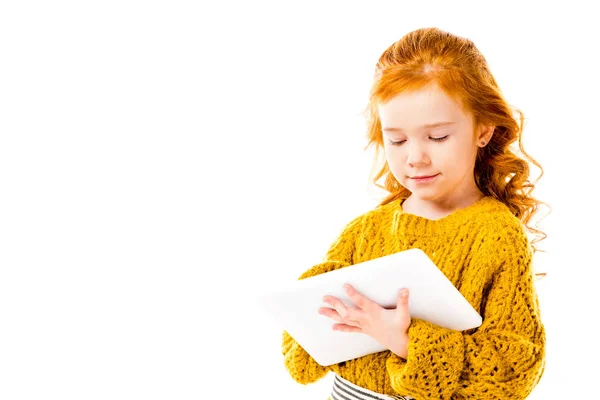 Red hair kid looking at tablet isolated on white — Stock Photo