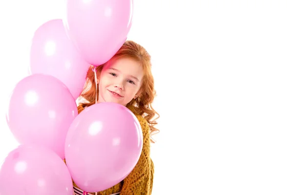 Red hair child standing with bundle of pink balloons isolated on white — Stock Photo