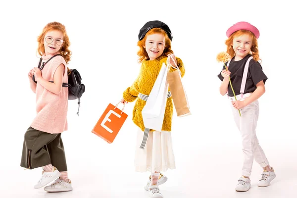 Collage mit demselben Kind in verschiedenen Kleidern und mit verschiedenen Dingen auf Weiß — Stockfoto
