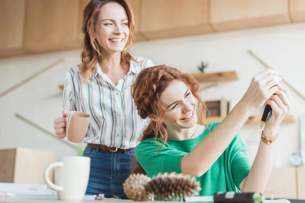 Young women having fun in handmade accessories workshop — Stock Photo