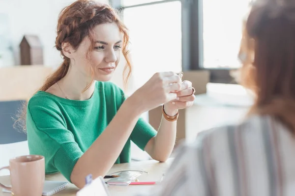 Beautiful young woman making accessory in handmade workshop — Stock Photo