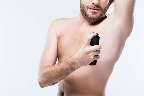 Imagem cortada do homem usando spray desodorizante com a mão atrás da cabeça, isolado em branco — Fotografia de Stock