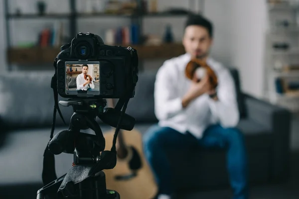 Sport blogger recording new video about baseball with camera on foreground — Stock Photo