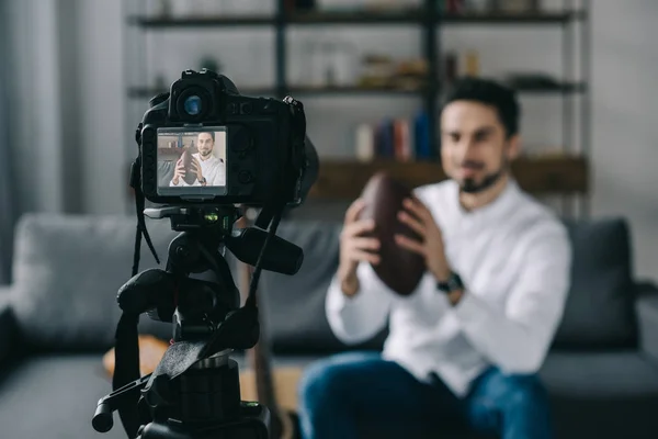 Sport blogger recording new video about handball with camera on foreground — Stock Photo