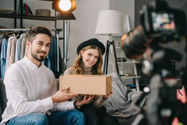 Smiling fashion bloggers holding box — Stock Photo