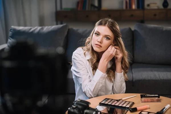 Attractive beauty blogger wearing earring — Stock Photo