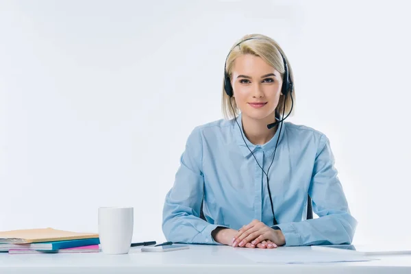 Portrait of young smiling call center operator in headset at workplace — Stock Photo