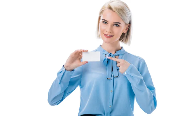 Portrait of smiling woman pointing at empty card in hand isolated on white — Stock Photo