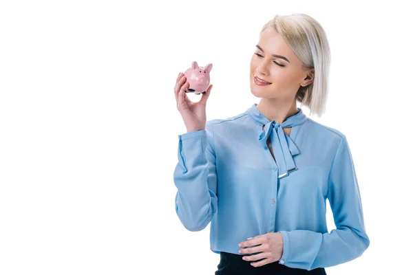 Portrait of smiling businesswoman showing piggy bank isolated on white — Stock Photo