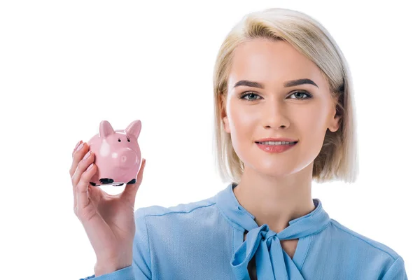 Portrait of smiling businesswoman showing piggy bank isolated on white — Stock Photo
