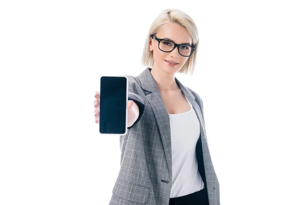 Attractive stylish businesswoman showing smartphone, isolated on white — Stock Photo