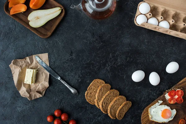 Flat lay with ingredients for healthy breakfast on dark tabletop — Stock Photo