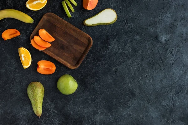 Flat lay with ingredients for healthy breakfast on dark tabletop — Stock Photo