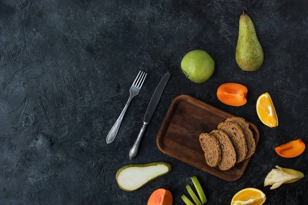 Flat lay with ingredients for healthy breakfast on dark tabletop — Stock Photo