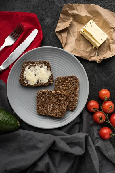 Vista superior de rebanadas de pan con mantequilla para el desayuno en el plato - foto de stock