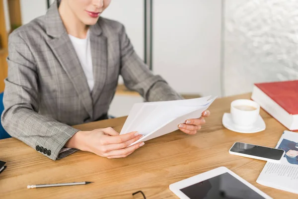 Cropped shot of businesswoman doing paperwork at workplace in office — Stock Photo