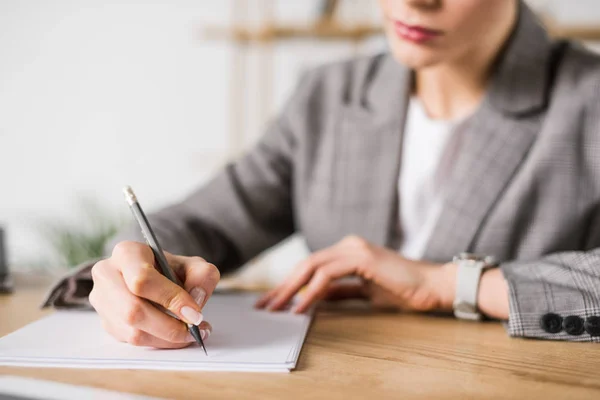 Partial view of businesswoman doing paperwork at workplace in office — Stock Photo