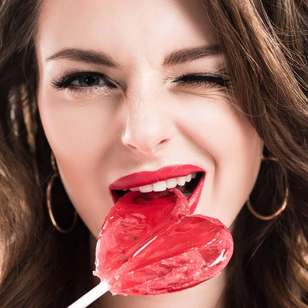 Seductive girl biting heart shaped lollipop, valentines day concept — Stock Photo