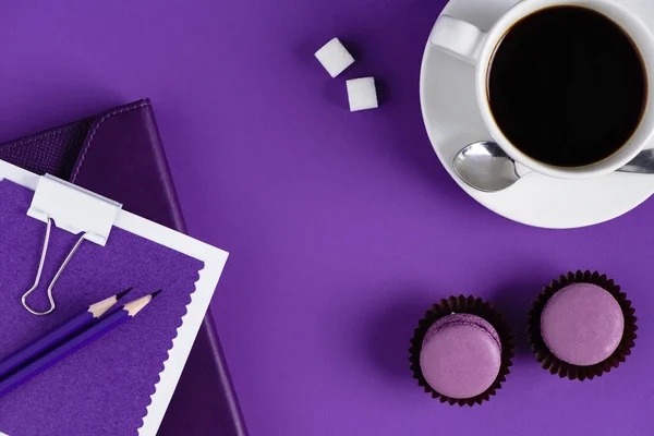 Vista superior del espacio de trabajo con taza de café y cupcakes - foto de stock