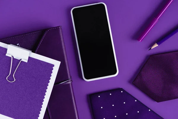 Top view of stylish workspace in purple color shades with smartpohone and supplies — Stock Photo