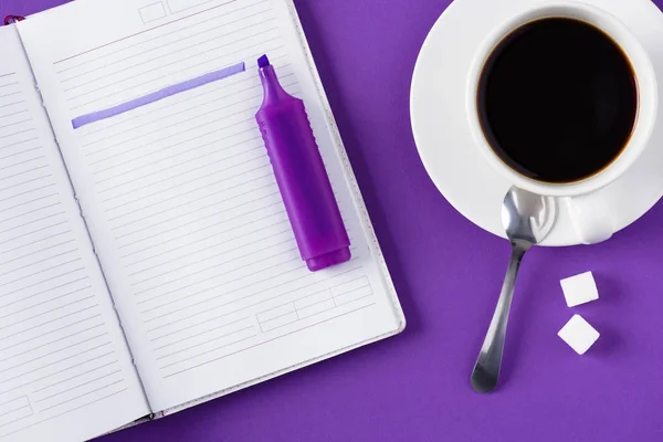 Top view of workspace with opened notebook and cup of coffee — Stock Photo