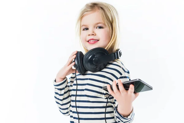 Beautiful little child with headphones and smartphone isolated on white — Stock Photo