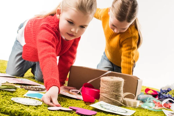 Close-up shot of little sisters making diy greeting cards isolated on white — Stock Photo